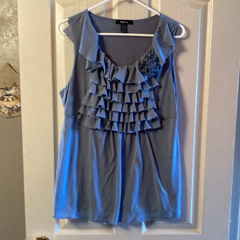 Ruffles and “flower” embellish the front